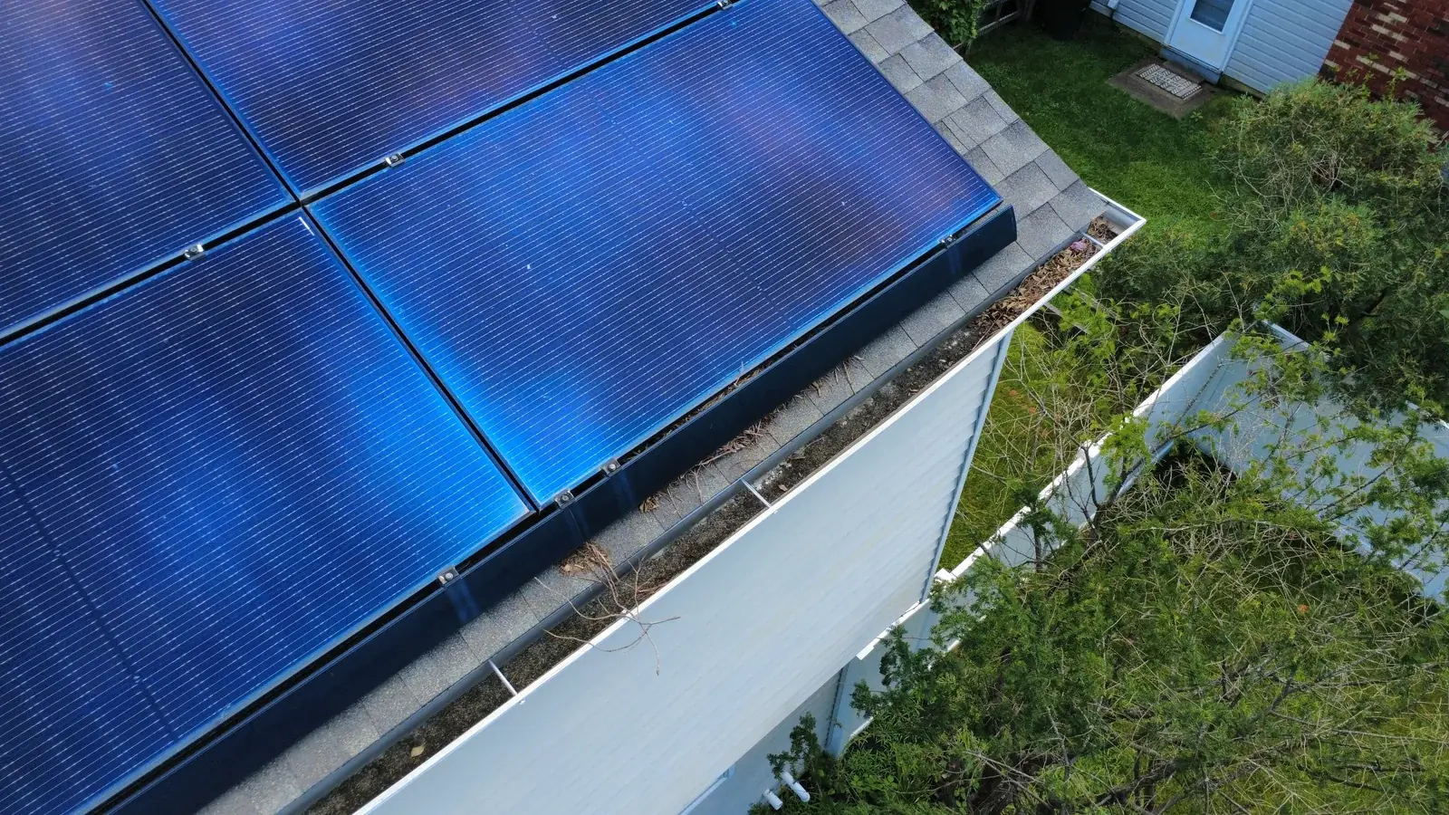 Existing panels and gutter debris before work
