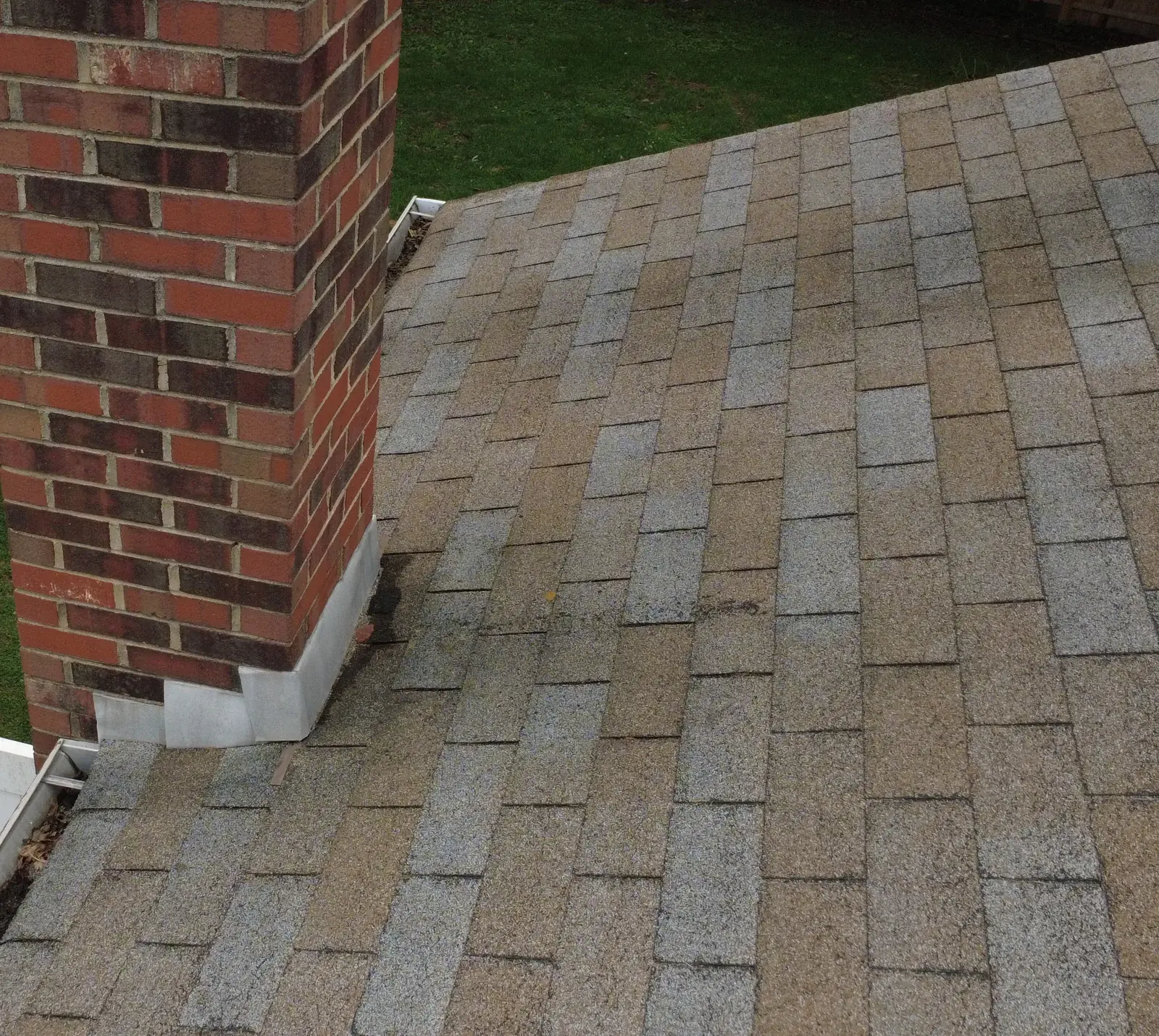 Existing chimney-side roof detail during inspection