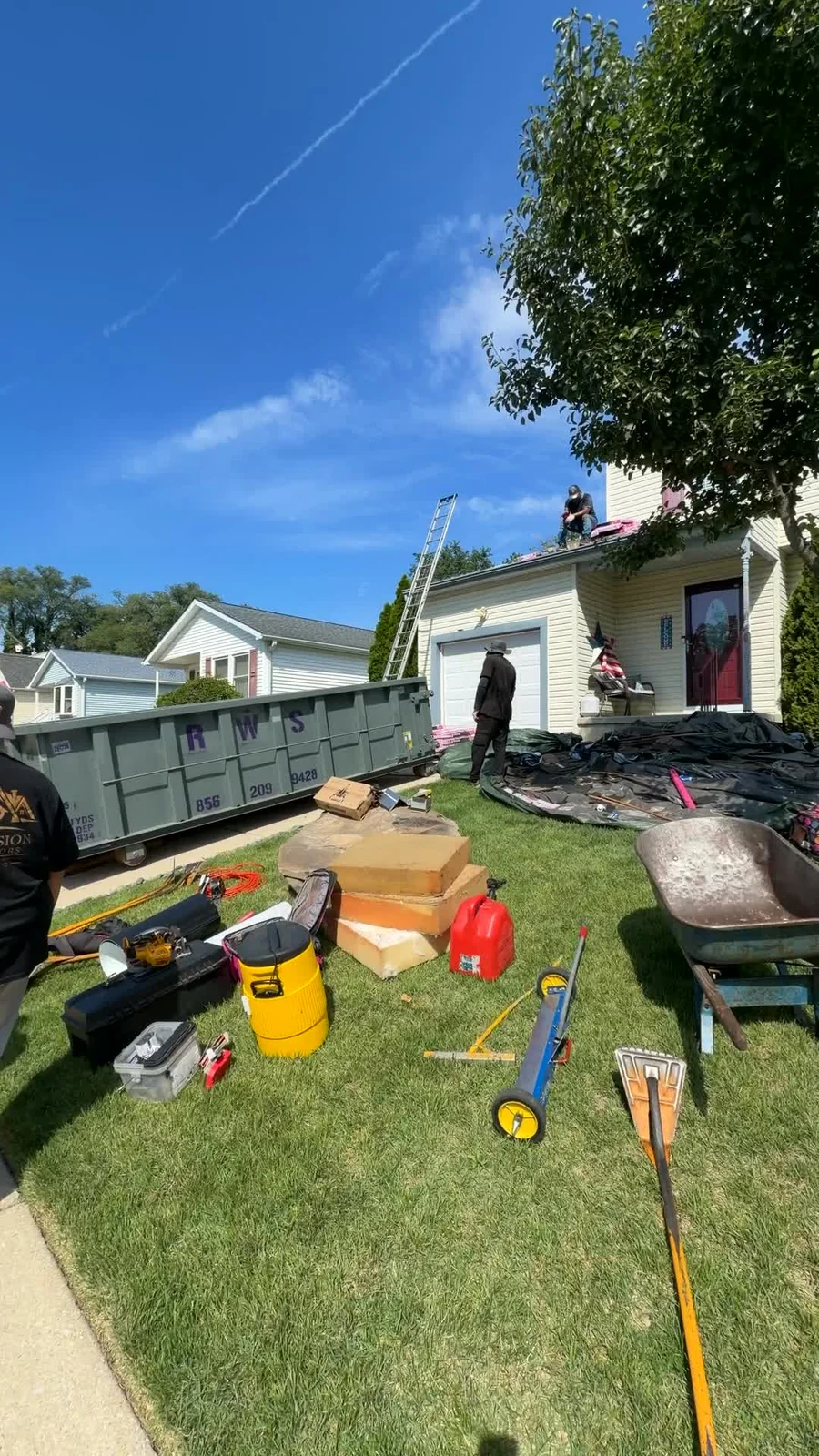 Crew, ladder and materials during roof work