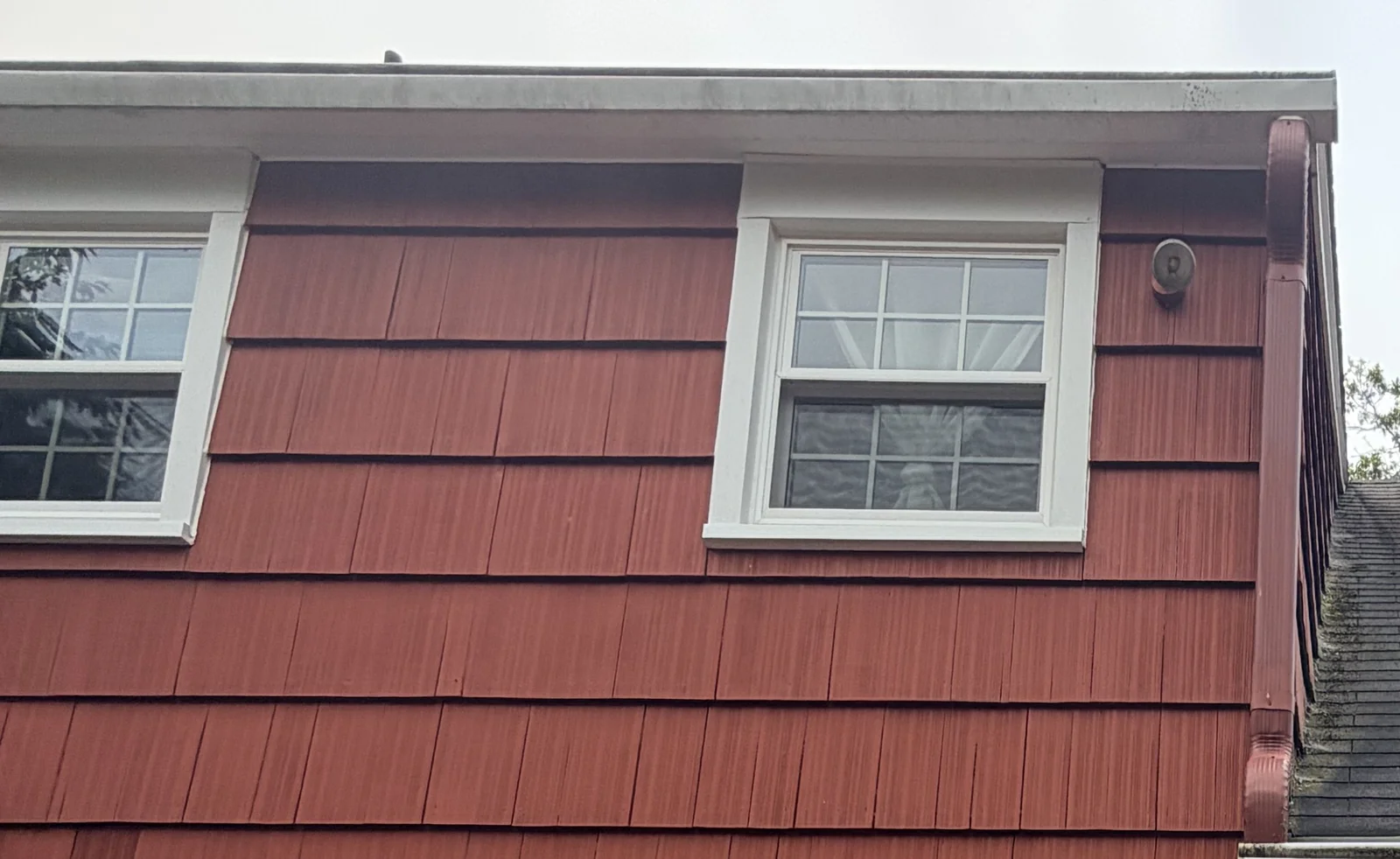 Existing rear gutter and downspout during inspection