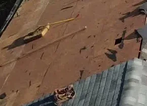 Exposed decking and removed shingle layers during tear-off