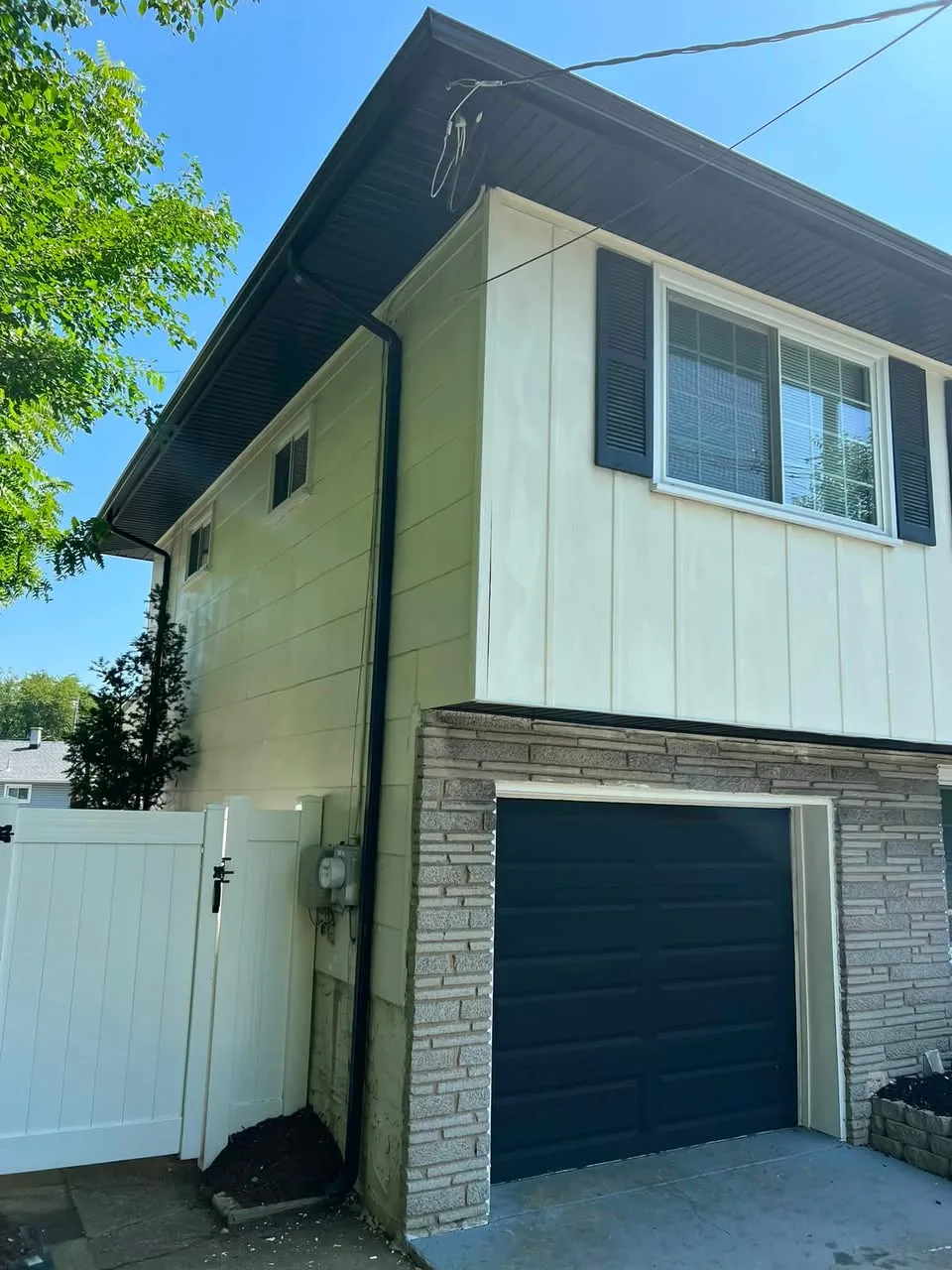 Side view of black soffit, fascia, gutter, and downspout work in Deptford