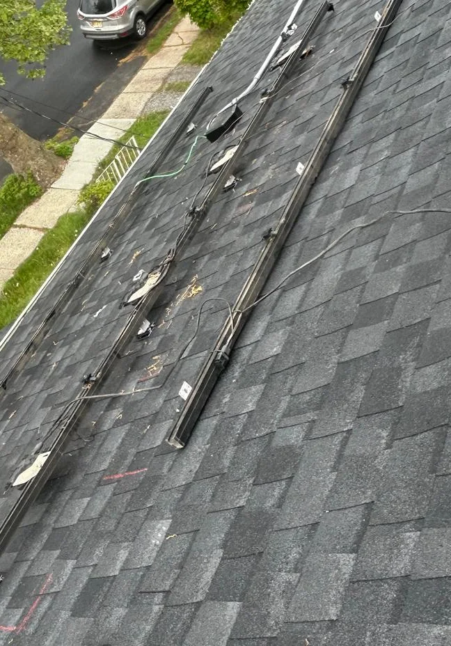 Exposed solar support rails and cabling with panels absent in Hillside, New Jersey