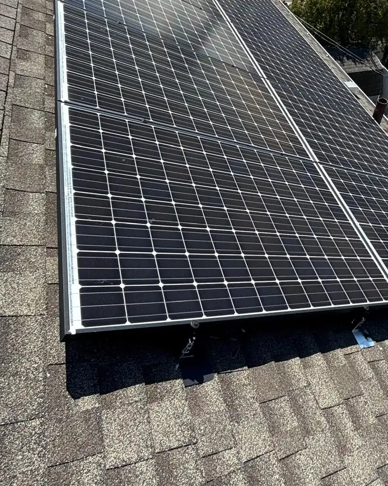 Silver solar panel frames and mounting hardware at the lower array edge in Margate City, New Jersey
