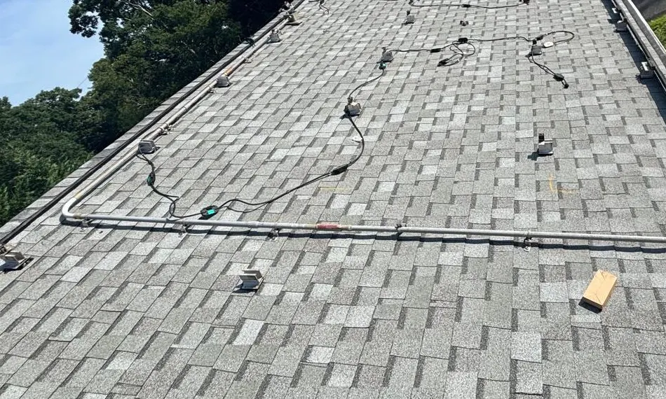 Exposed solar cable runs and mounting points from a 26-panel project in Northfield, New Jersey