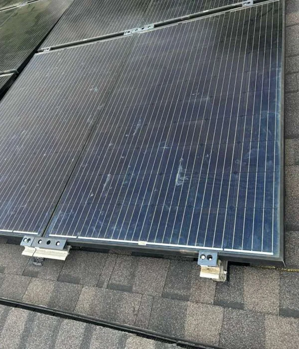 Solar panel faces, lower frame edge, and metal mounting clips in Rahway, New Jersey