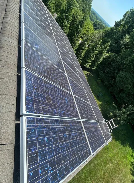 Dark solar modules with silver frames in repeated rows from a 36-panel project in Wilmington, Delaware