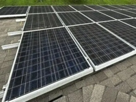 Dark solar modules with silver frames in repeated rows in Wilmington, Delaware